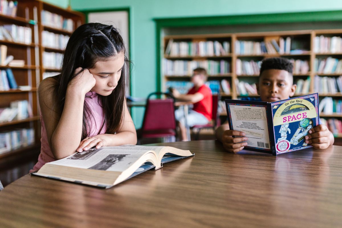 Illustrative photograph of children reading in a library